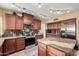 Well-equipped kitchen featuring granite countertops, dark wood cabinets, stainless steel appliances, and ample counter space at 844 W Sherri Dr, Gilbert, AZ 85233