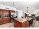 Open kitchen with stainless appliances, granite counters, tile floors, recessed lighting, and large island at 844 W Sherri Dr, Gilbert, AZ 85233