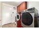 Well-equipped laundry room with modern washer and dryer, storage cabinets, and convenient exterior access at 844 W Sherri Dr, Gilbert, AZ 85233