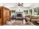Cozy living room with a stone fireplace, hardwood floors, and ample seating at 844 W Sherri Dr, Gilbert, AZ 85233
