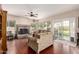 Spacious living room with a stone fireplace, wood floors, and sliding glass doors leading to outdoor space at 844 W Sherri Dr, Gilbert, AZ 85233