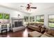 Bright living room with a stone fireplace, large windows, and natural light at 844 W Sherri Dr, Gilbert, AZ 85233