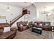 Open living room with a staircase, plush seating, and natural light at 844 W Sherri Dr, Gilbert, AZ 85233