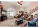 Bright living room featuring vaulted ceilings, a ceiling fan, and large windows at 844 W Sherri Dr, Gilbert, AZ 85233