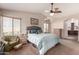 Primary bedroom featuring carpet, vaulted ceiling, ceiling fan, arched window, and doorway at 844 W Sherri Dr, Gilbert, AZ 85233