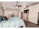 Primary bedroom featuring vaulted ceiling, ceiling fan, and hallway to bathroom at 844 W Sherri Dr, Gilbert, AZ 85233