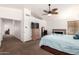 Main bedroom with vaulted ceiling, ceiling fan, carpet floors, fireplace, and large windows at 844 W Sherri Dr, Gilbert, AZ 85233