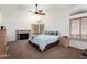 Main bedroom with vaulted ceiling, fireplace, ceiling fan, carpet floors, and large windows at 844 W Sherri Dr, Gilbert, AZ 85233