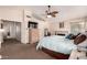 Spacious primary bedroom featuring vaulted ceiling, ceiling fan, and stone fireplace at 844 W Sherri Dr, Gilbert, AZ 85233