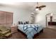 Main bedroom with vaulted ceiling, ceiling fan, carpet floors, and large windows with blinds at 844 W Sherri Dr, Gilbert, AZ 85233
