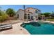 A beautiful backyard pool with a two-story home in the background and a spacious backyard at 844 W Sherri Dr, Gilbert, AZ 85233