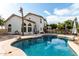 Back of the house showcasing a private pool with a rock border and a patio area with outdoor furniture at 844 W Sherri Dr, Gilbert, AZ 85233