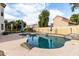 Inviting in-ground pool featuring a rock border, and a patio area with umbrellas and outdoor furniture at 844 W Sherri Dr, Gilbert, AZ 85233