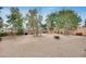 Large backyard area boasting trees and gravel for a well maintained aesthetic at 9364 W Cordes Rd, Tolleson, AZ 85353