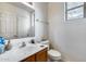 Bright bathroom features a pedestal sink, a toilet, and a window that brings in natural light at 9364 W Cordes Rd, Tolleson, AZ 85353