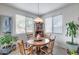 Cozy dining area featuring a round wooden table, four chairs, and natural light at 9364 W Cordes Rd, Tolleson, AZ 85353
