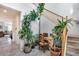 Bright entryway with staircase, tile flooring, and an assortment of green plants at 9364 W Cordes Rd, Tolleson, AZ 85353