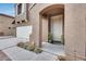 Inviting front entrance with a white door, plants, and manicured landscaping at 9364 W Cordes Rd, Tolleson, AZ 85353