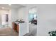 Hallway featuring built-in desk with wood chair leading to a bedroom and bathroom at 9364 W Cordes Rd, Tolleson, AZ 85353