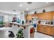 Bright eat-in kitchen with light wood cabinets, white appliances, and tile flooring at 9364 W Cordes Rd, Tolleson, AZ 85353