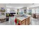 Open-concept layout connects the kitchen and living room, enhanced by tile flooring at 9364 W Cordes Rd, Tolleson, AZ 85353