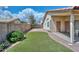 Side view of the backyard featuring artificial grass and block fence for privacy at 9837 W Tonopah Dr, Peoria, AZ 85382