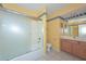 Well-lit bathroom with tub and frosted glass sliding door and single sink vanity at 9837 W Tonopah Dr, Peoria, AZ 85382