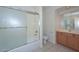 Bathroom with shower/tub combination, tiled floors, and light-stained wood cabinets at 9837 W Tonopah Dr, Peoria, AZ 85382