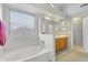 Inviting bathroom offering a large window, soaking tub, and vanity at 9837 W Tonopah Dr, Peoria, AZ 85382