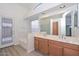 Bathroom features double sink vanity, soaking tub, and wood-look flooring at 9837 W Tonopah Dr, Peoria, AZ 85382