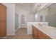 Bright bathroom features a double sink vanity, a walk in shower, and wood-look flooring at 9837 W Tonopah Dr, Peoria, AZ 85382