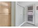 Clean bathroom offers linen storage, walk-in shower, and access to patio at 9837 W Tonopah Dr, Peoria, AZ 85382