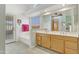 Bright bathroom features a double vanity, soaking tub, and access to the patio at 9837 W Tonopah Dr, Peoria, AZ 85382