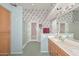 Bright bathroom features a double vanity, shower, and access to the patio at 9837 W Tonopah Dr, Peoria, AZ 85382