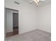 Bedroom with carpet, a ceiling fan, a light-colored walls, and an open doorway at 9837 W Tonopah Dr, Peoria, AZ 85382