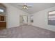Carpeted bedroom with ceiling fan and closet with mirrored doors at 9837 W Tonopah Dr, Peoria, AZ 85382