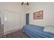 Comfortable bedroom with closet and blue bedding plus view of open door at 9837 W Tonopah Dr, Peoria, AZ 85382