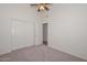 Bedroom with carpeted floors, vaulted ceilings, and closet with sliding doors at 9837 W Tonopah Dr, Peoria, AZ 85382