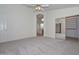 Carpeted bedroom with ceiling fan and closet with mirrored doors at 9837 W Tonopah Dr, Peoria, AZ 85382