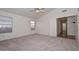 Carpeted bedroom with two windows and large closet at 9837 W Tonopah Dr, Peoria, AZ 85382