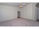Carpeted bedroom with ceiling fan and a wide entry way at 9837 W Tonopah Dr, Peoria, AZ 85382