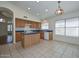 Bright eat-in kitchen features wood cabinets, blue countertops, and tile flooring at 9837 W Tonopah Dr, Peoria, AZ 85382