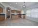 Bright eat-in kitchen features wood cabinets, blue countertops, and tile flooring at 9837 W Tonopah Dr, Peoria, AZ 85382