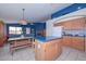 Open kitchen concept that flows to a living area, showcasing wood cabinets and an island at 9837 W Tonopah Dr, Peoria, AZ 85382