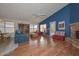 Spacious living room with hardwood floors, a cozy fireplace, and ample natural light at 9837 W Tonopah Dr, Peoria, AZ 85382