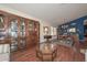 Spacious interior featuring hardwood floors and an elegant built-in display cabinet at 9837 W Tonopah Dr, Peoria, AZ 85382
