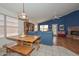 The eating area flows to the living room with plenty of light from the large windows at 9837 W Tonopah Dr, Peoria, AZ 85382