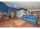Inviting living space featuring a brick fireplace, hardwood floors, and comfortable seating at 9837 W Tonopah Dr, Peoria, AZ 85382