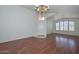 Spacious living room with wood floors, ample natural light, and an elegant chandelier at 9837 W Tonopah Dr, Peoria, AZ 85382