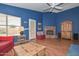 Cozy living room highlighted by a brick fireplace, hardwood floors, and classic decor at 9837 W Tonopah Dr, Peoria, AZ 85382